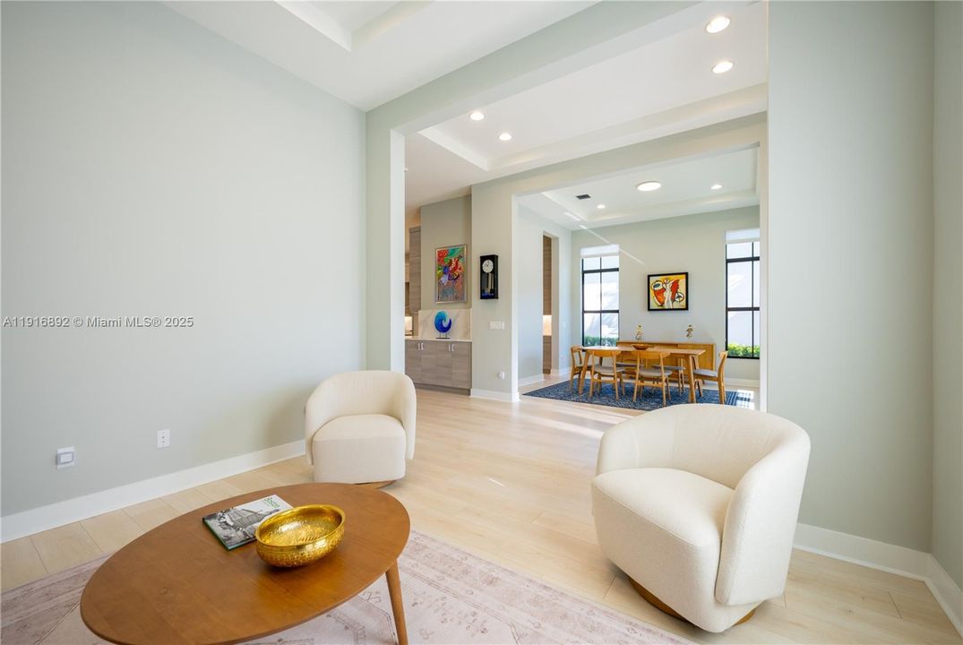 Living room and formal dining room connected by the inviting foyer