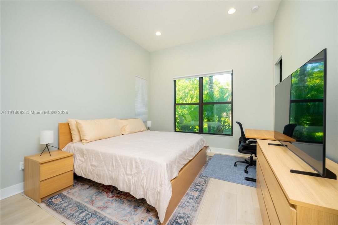 Large bedroom downstairs with a soaring ceiling