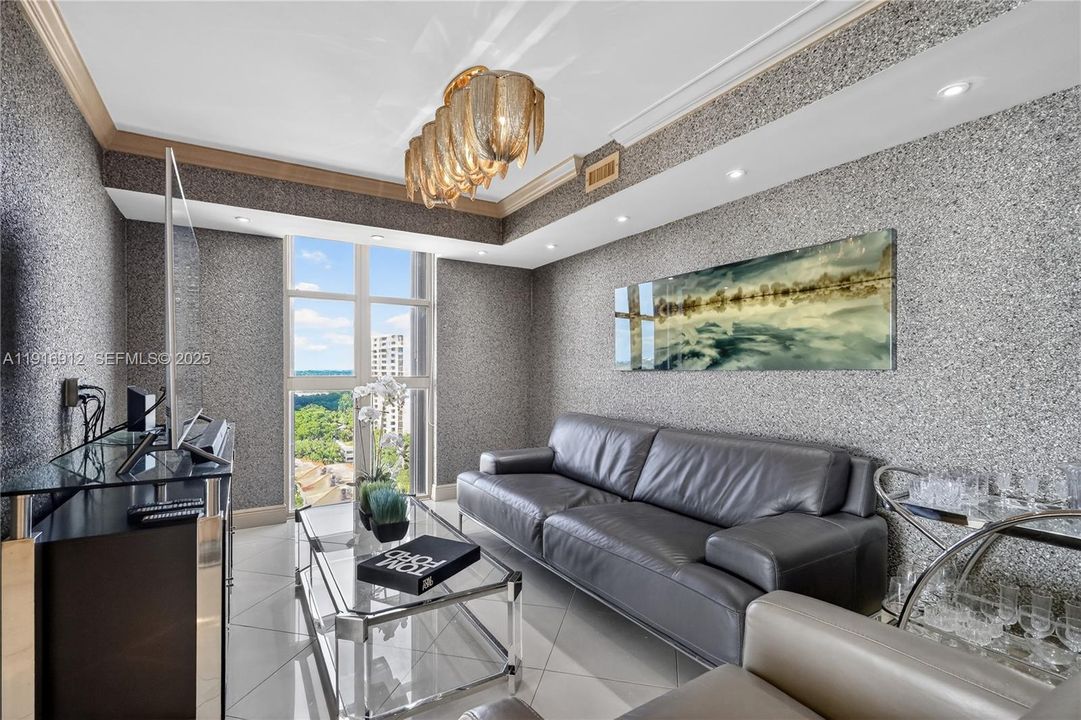 The living area is compact and inviting, featuring a TV set beside the window to make the most of the natural light