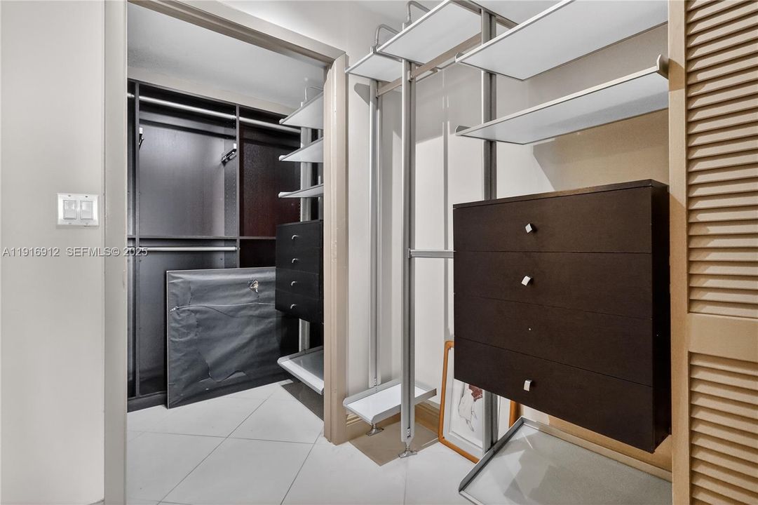 An expansive walk-in closet featuring generous hanging space, custom shelving, and abundant storage for a well-organized wardrobe