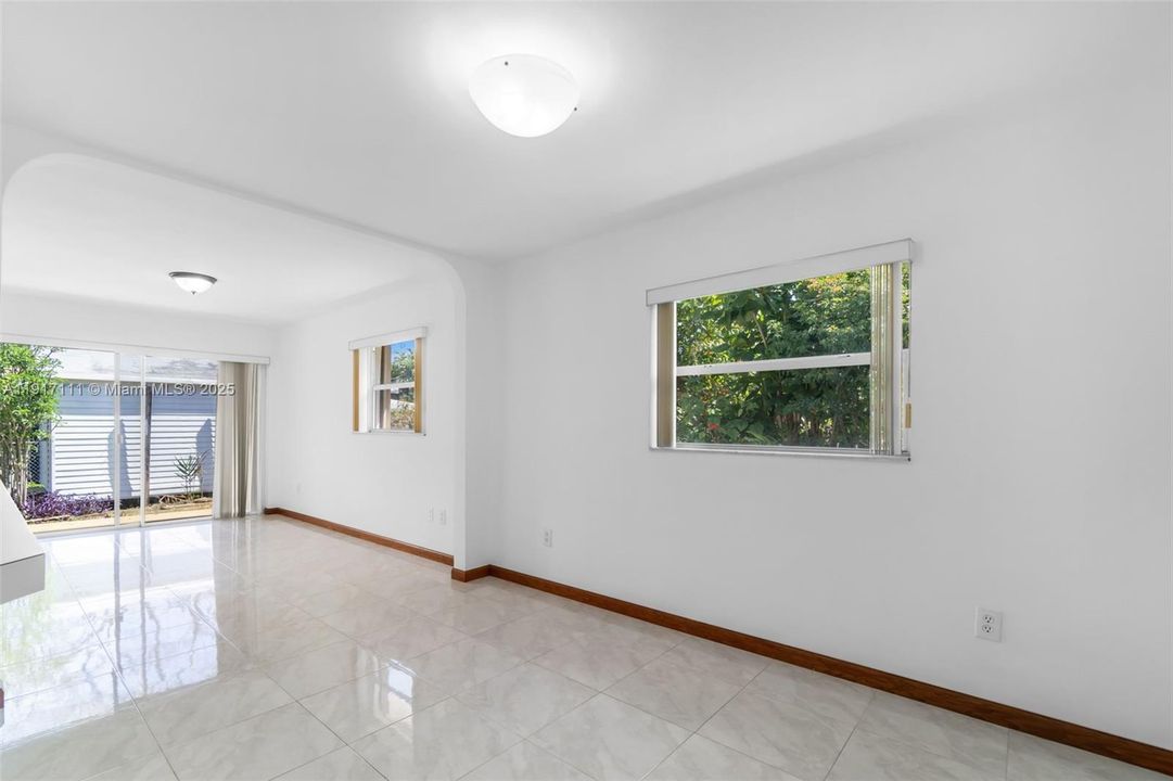 DINING ROOM WITH VIEW INTO SITTING AREA & SLIDERS TO BACKYARD