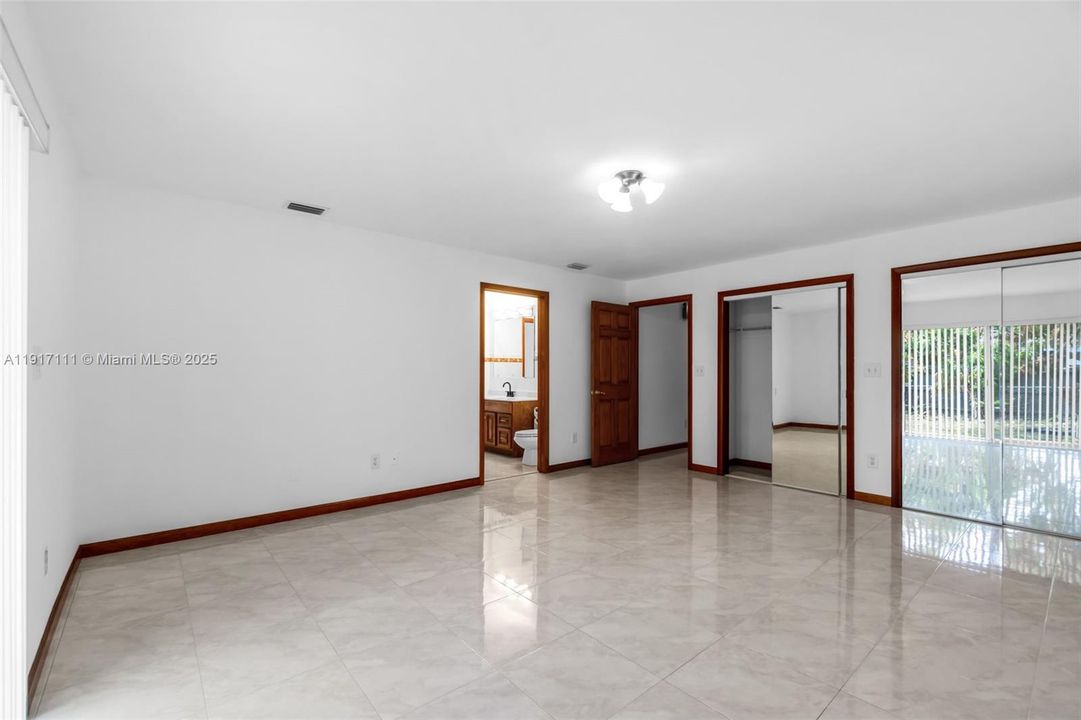 NICE SIZE ON PRIMARY BEDROOM #1 HAS SITTING AREA AND SLIDING DOORS TO THE BACKYARD.