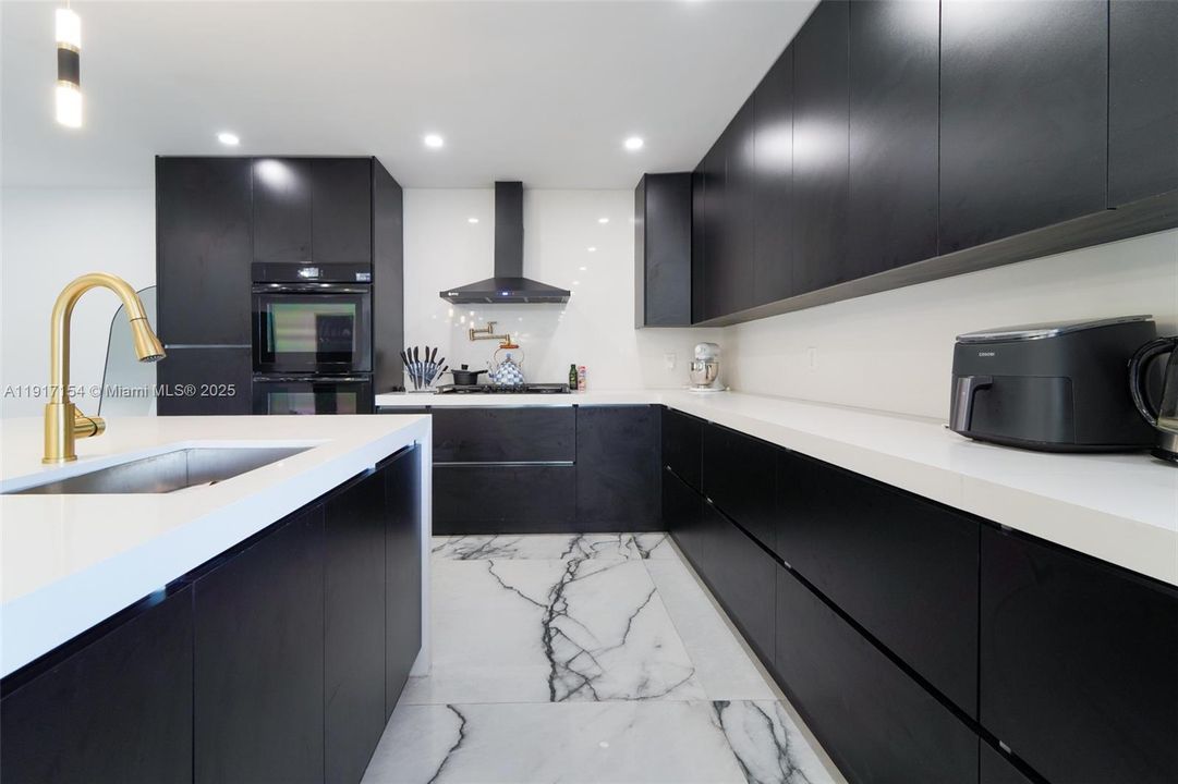 Extended countertop workspace with ample cabinetry and upgraded appliances.