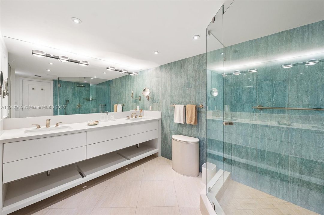 primary bath with enlarged shower and privacy water closet with bidet.