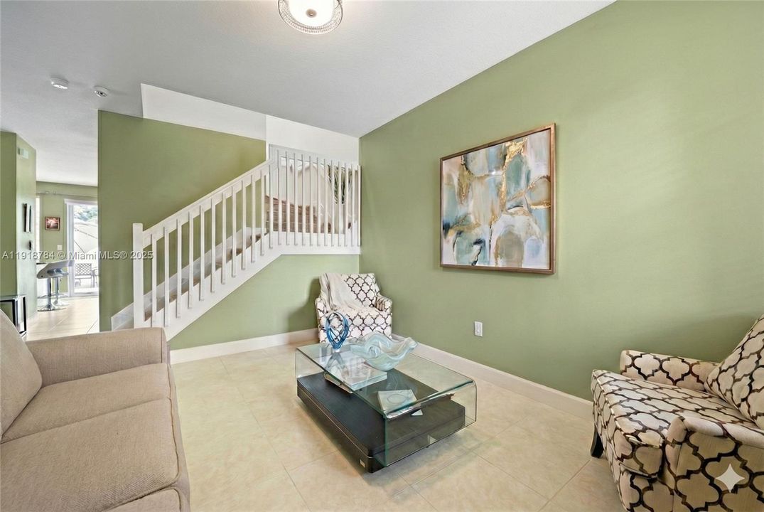 Bright front sitting room—perfect as a home office or reading retreat, virtually decluttered for presentation