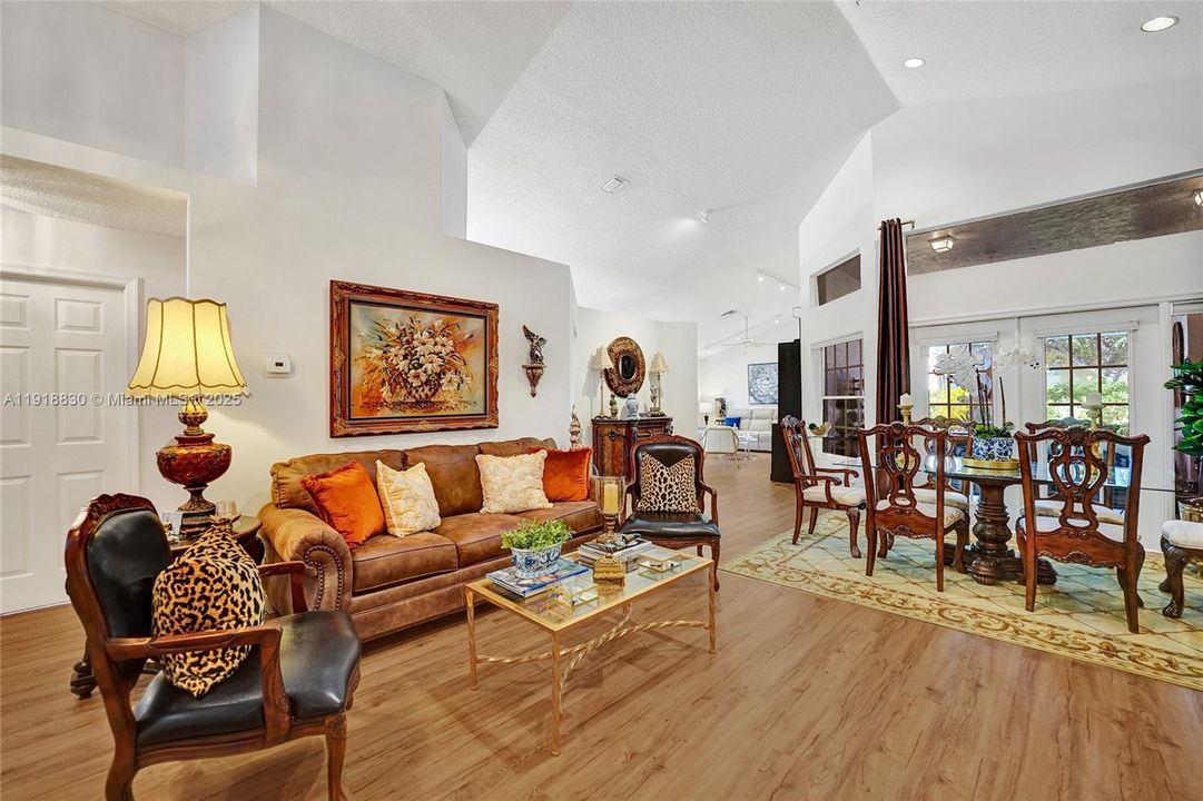 living room connects to a formal dining area and the sunroom