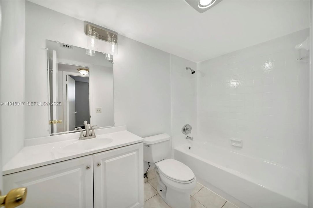 Newly Updated Guest bathroom with tub/shower and modern lighting