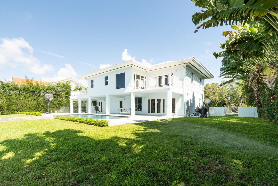 View of the pool area and covered terrace from the backyard