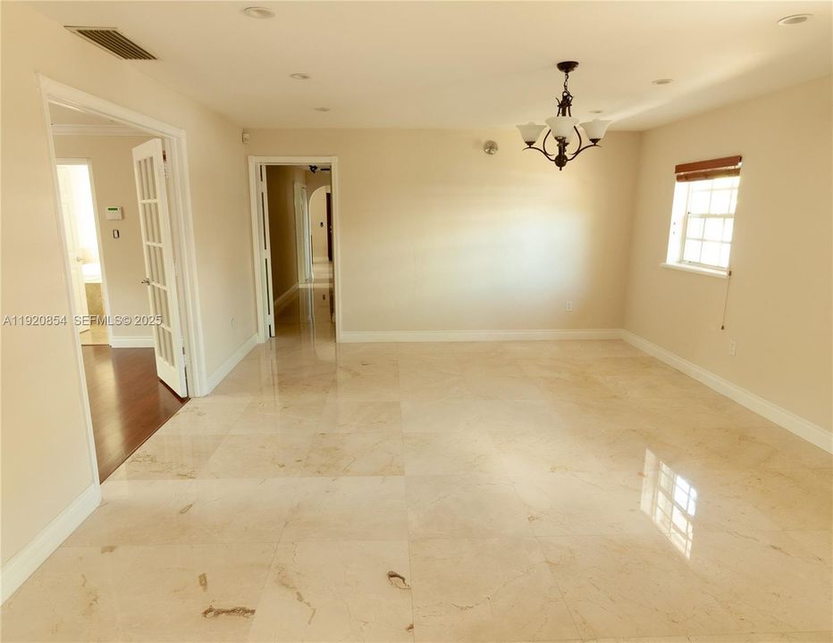 Dining room, and primary bedroom on the left. The second and third rooms are down the hall.