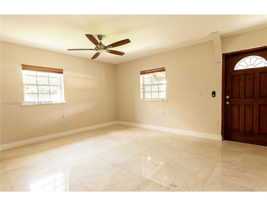 View of the recreation room leading to the backyard. This rec. room may be converted to a bedroom