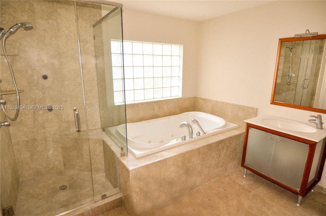 Master bathroom with walk-in shower, and hot tub.