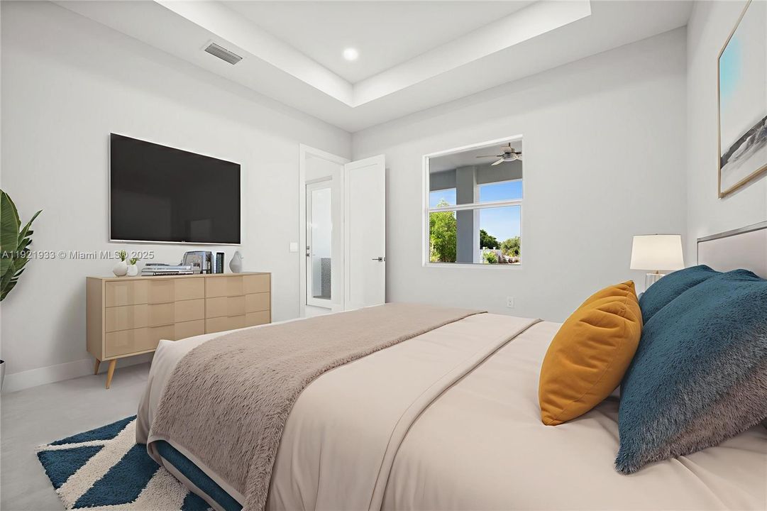 Bedroom featuring a raised ceiling andrecessed lighting