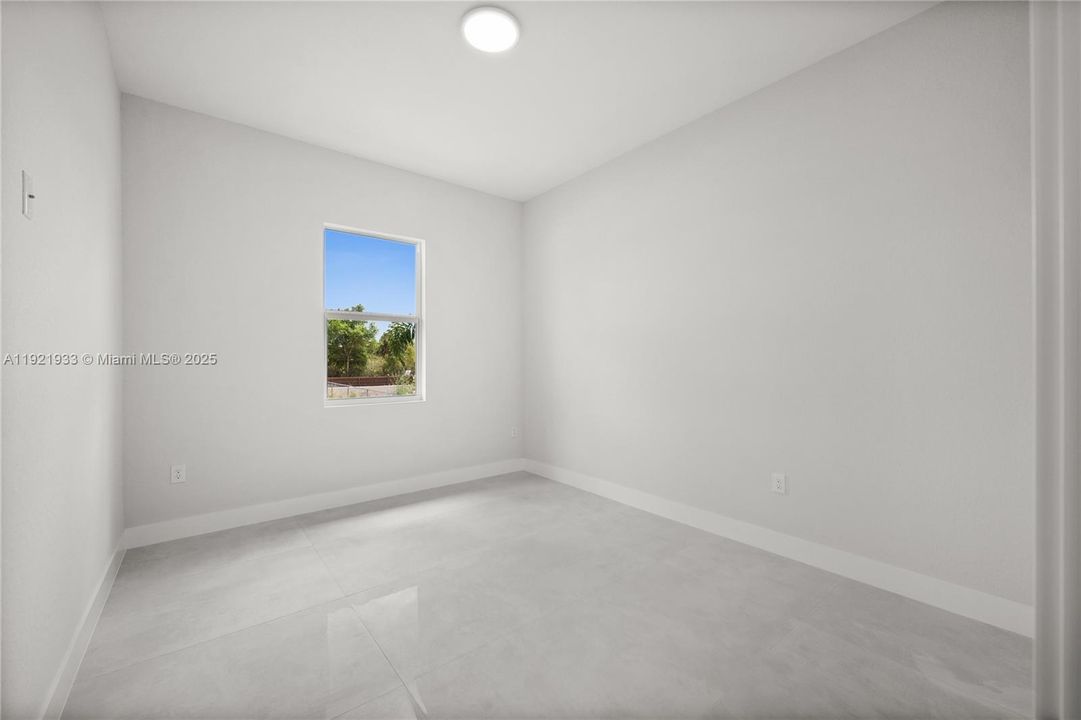 Empty room featuring baseboards