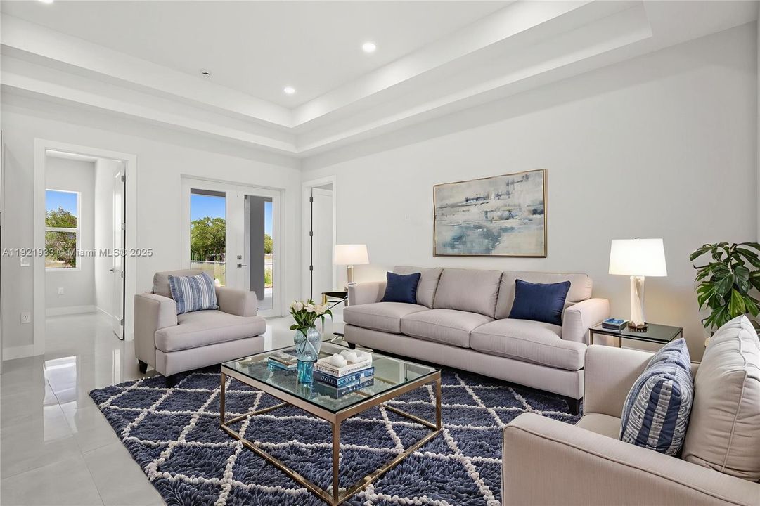 Tiled living area with a tray ceiling andrecessed lighting