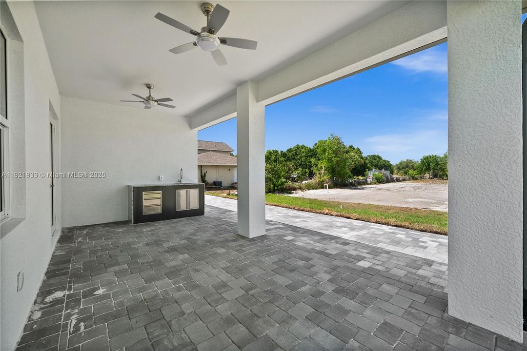 View of patio / terrace featuring ceiling fanand an outdoor kitchen