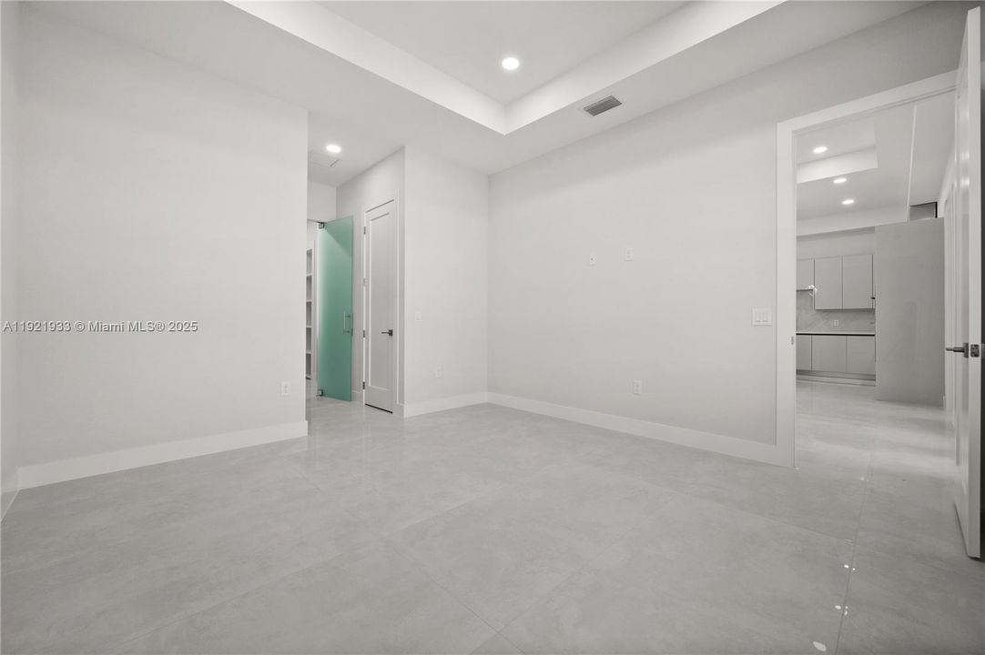Tiled living area with a tray ceiling andrecessed lighting
