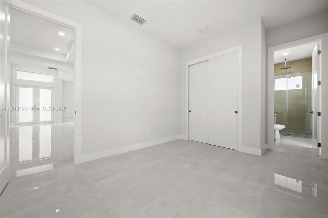 Unfurnished bedroom with french doors,recessed lighting, a closet, and connectedbathroom
