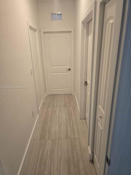 Hallway leading to bedroom and bathroom