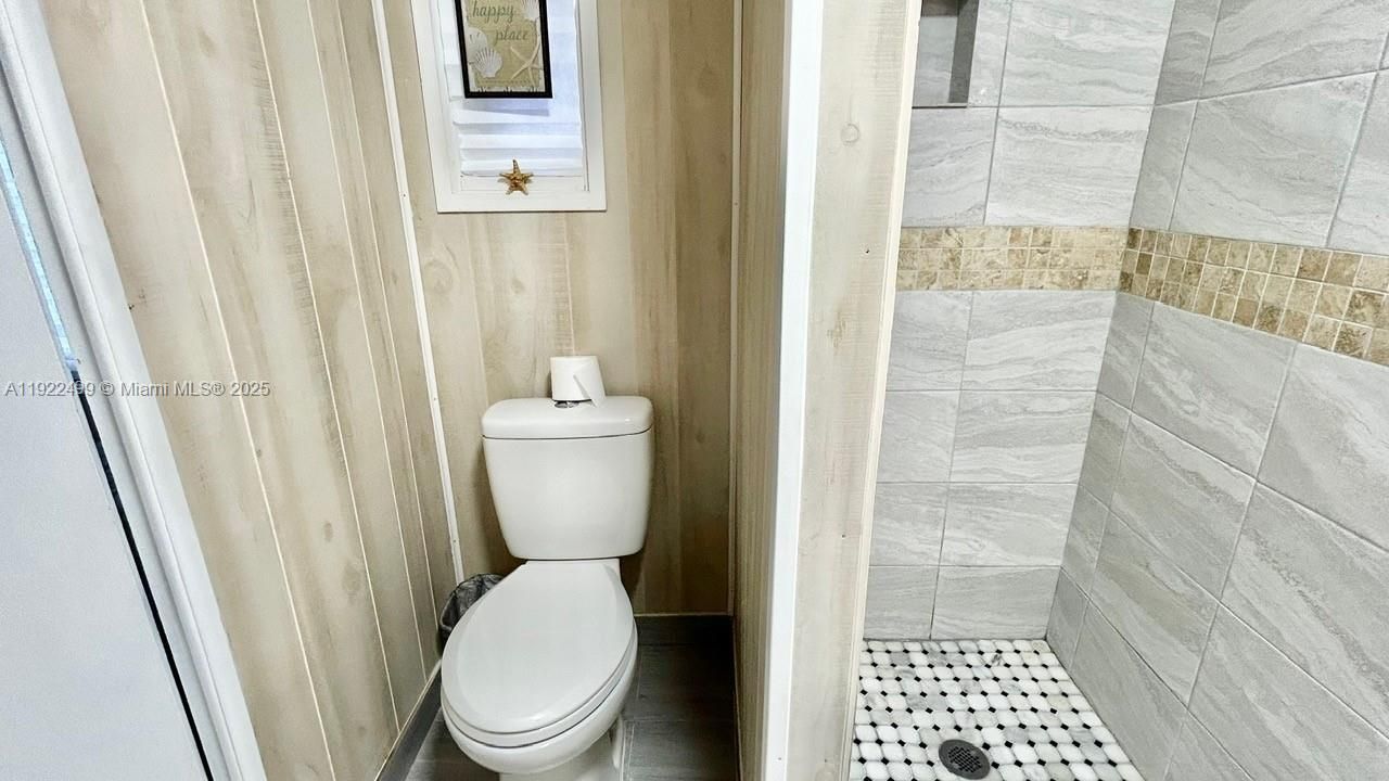 SECOND BATH SHOWING TOILET AND SHOWER