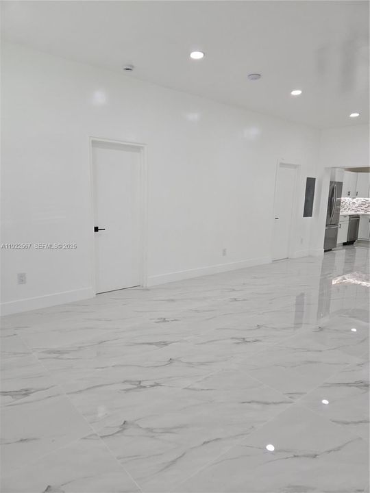 Living Room. Entry Door to Bedroom 1 on the left wing