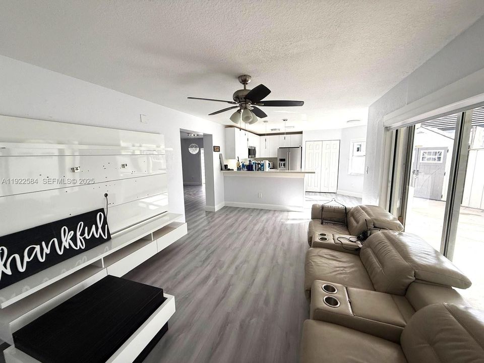 PRIMARY BEDROOM WITH TWO WALK-IN CLOSETS AND CONTEMPORARY CHANDELIER.