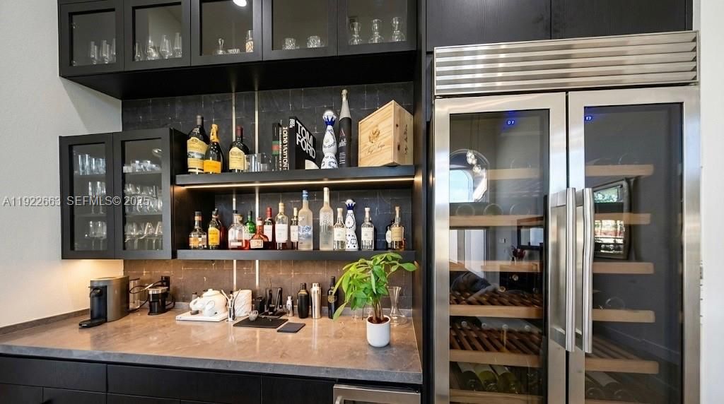 Family room bar with built ice maker and 350 bottle dual zone wine fridge