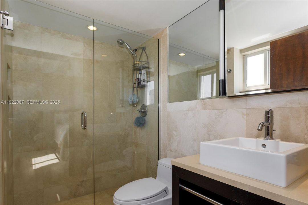 Luxurious bathroom featuring modern tile, glass shower, elegant vanity, and premium fixtures for a spa-like experience.