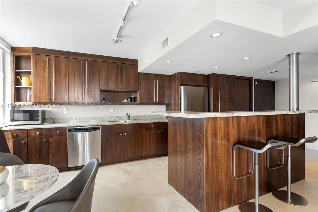 Fully upgraded kitchen with modern cabinetry, stainless steel appliances, premium countertops, and a spacious eat-in layout. Designed for functionality and style.