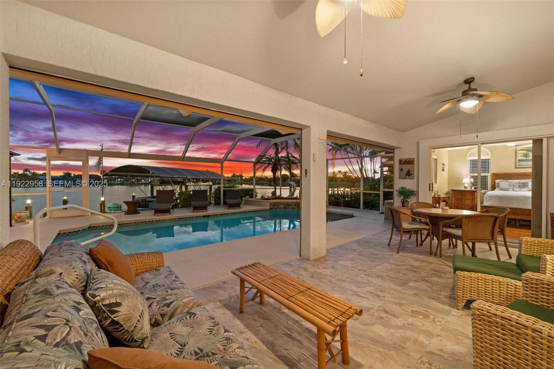 A view of the pool and lake from the covered lanai