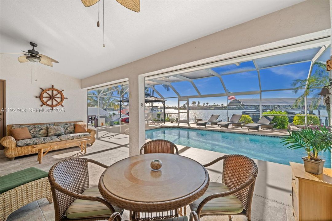Covered Lanai overlooking the pool and Gulf Access Lake