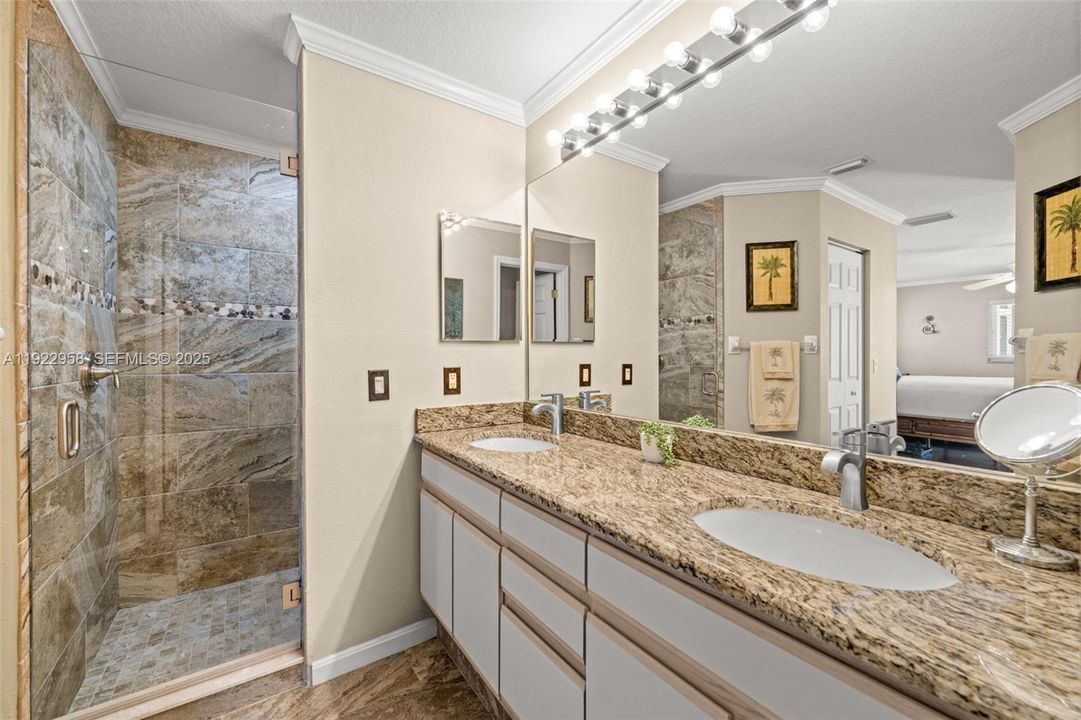 Primary Bath with dual sinks and tiled shower
