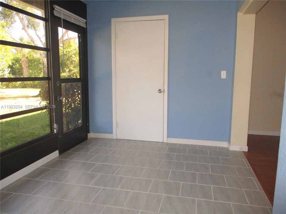 ENCLOSED TILE PATIO WITH STORAGE ROOM AT END