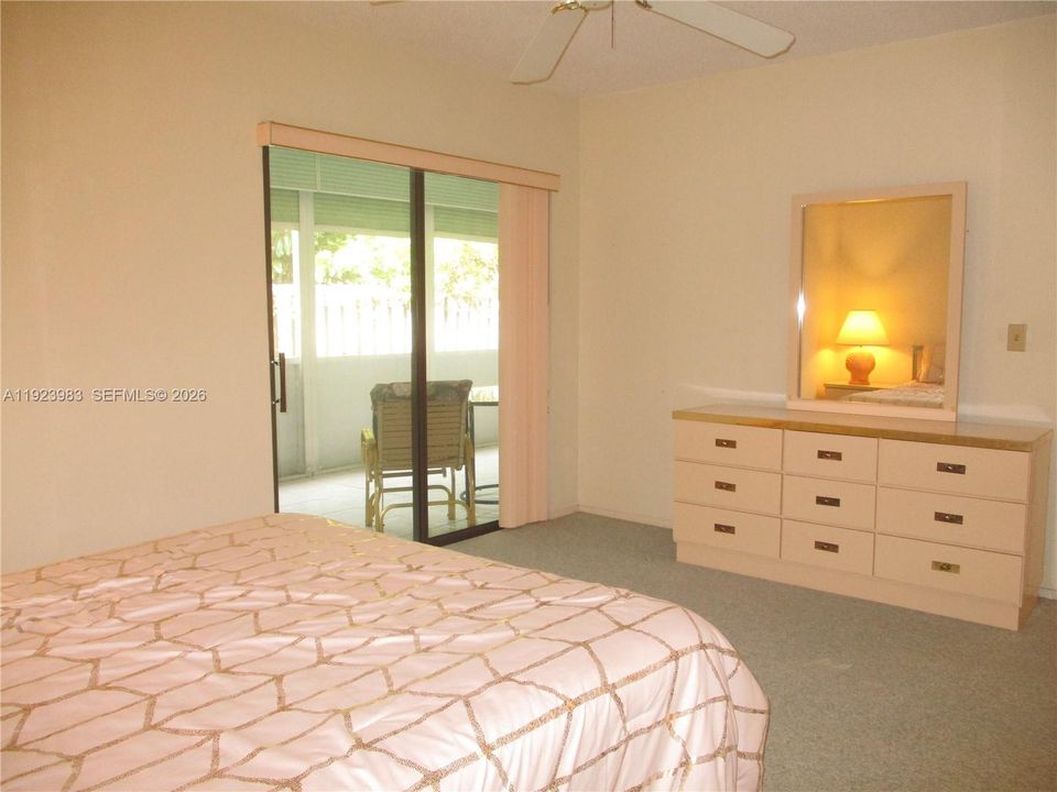 MASTER BEDROOM WITH SLIDING DOOR  TO SCREENED PATIO