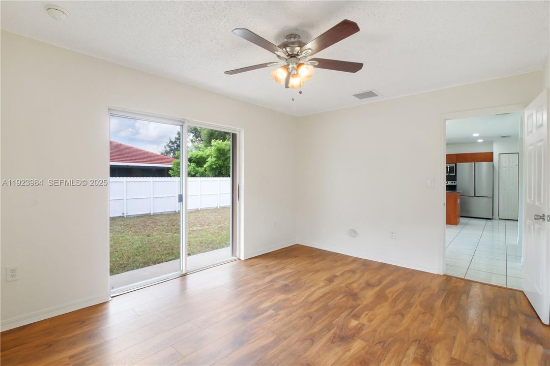 Primary suite with sliding glass door access to backyard