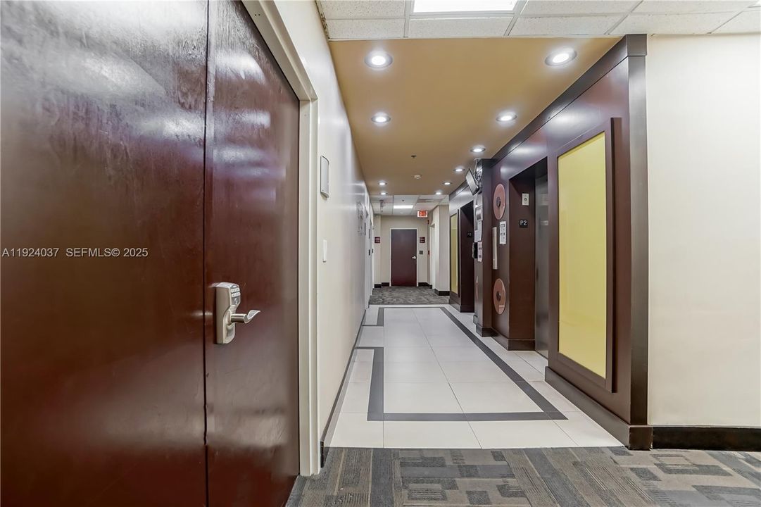 Hallway - Elevator on the right and the door on the left (facing North)