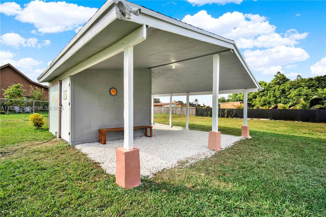Secure out-building structure with covered parking/storage area.