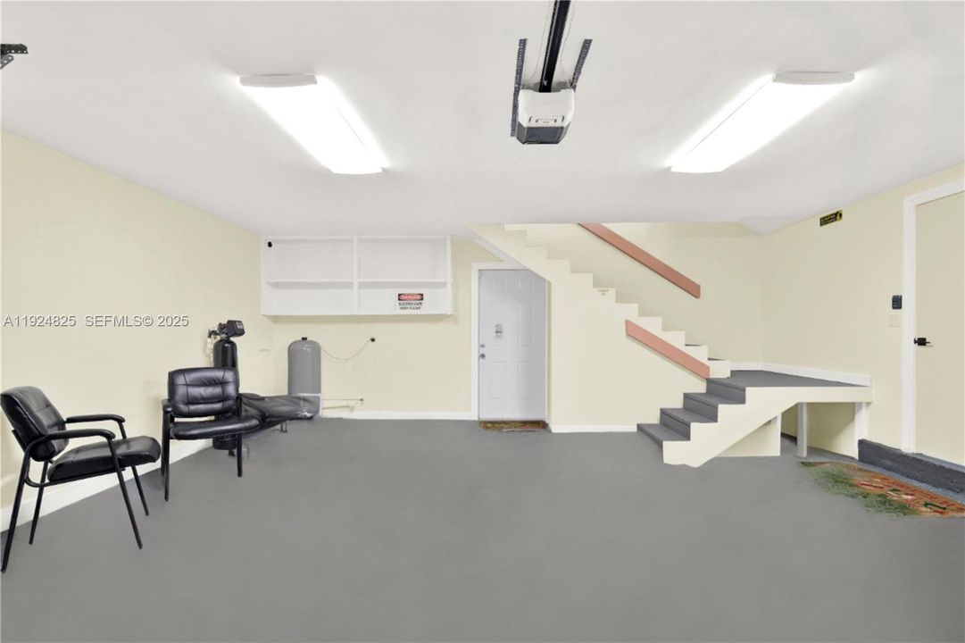 Two car garage with new epoxy floor and impact garage door in front and back.