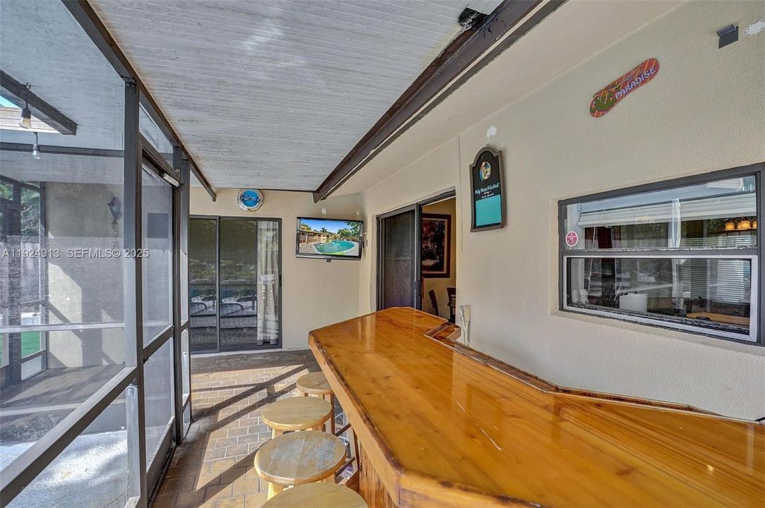 Screened in patio and bar.