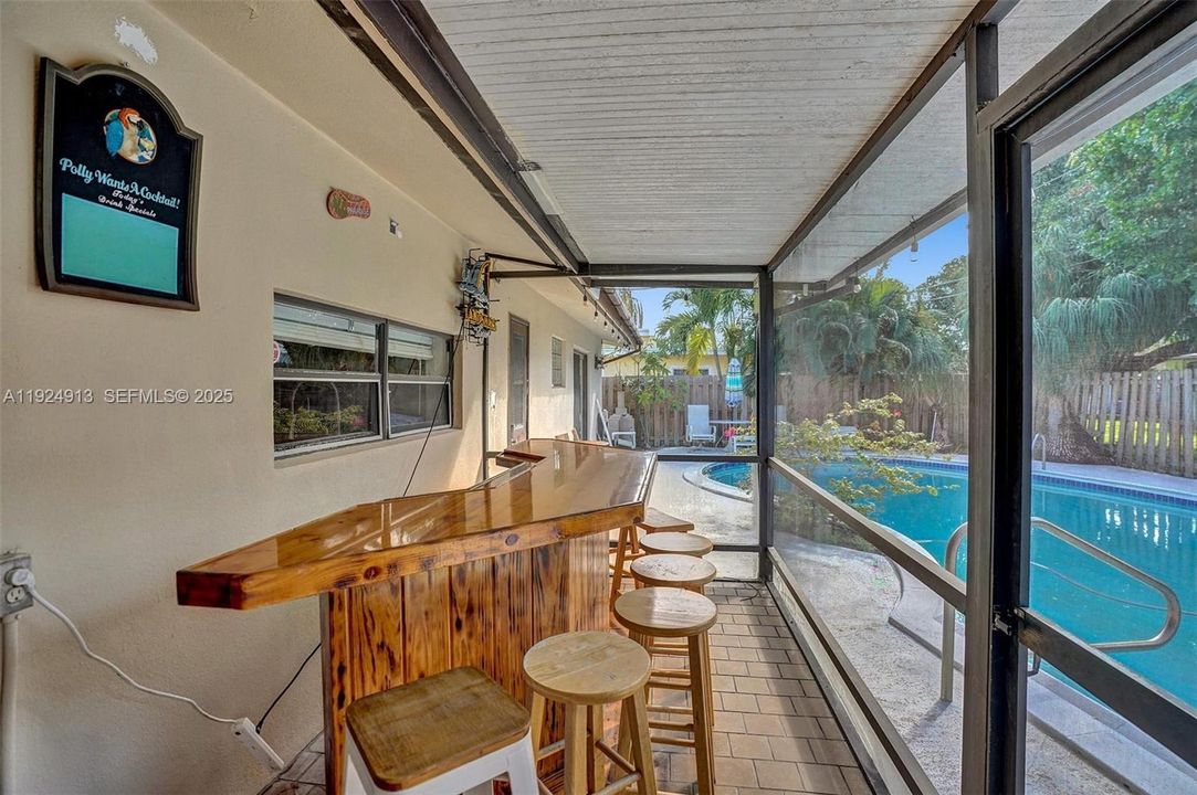Screened in patio and bar.