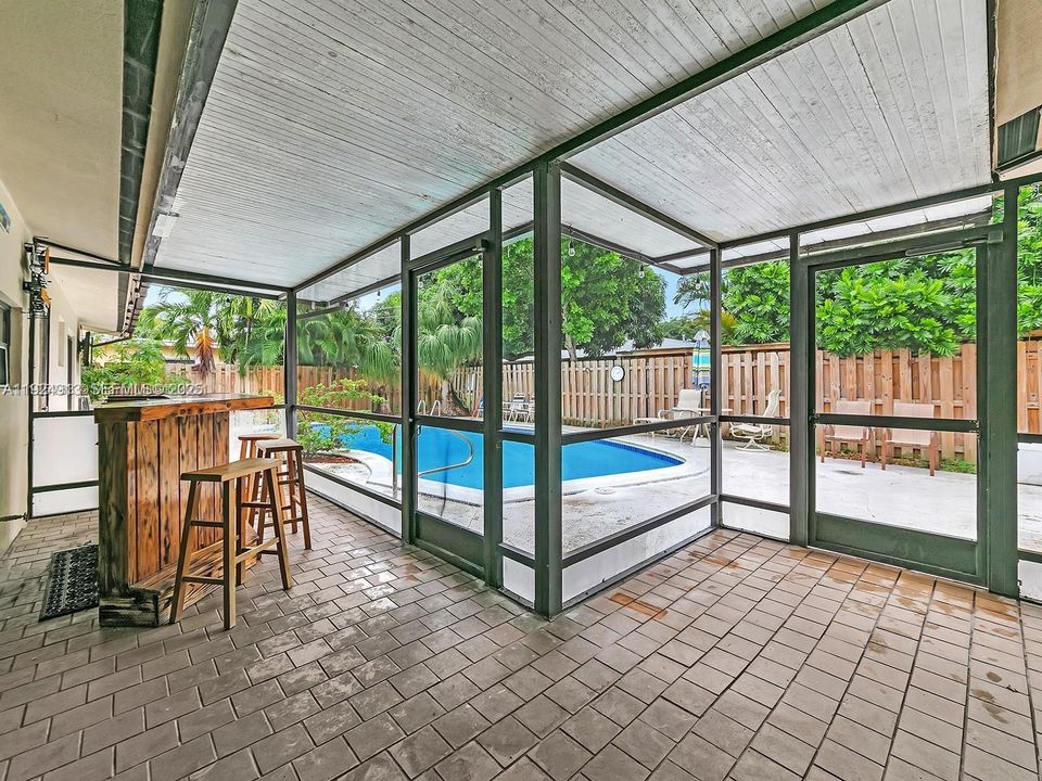 Screened in patio and bar.