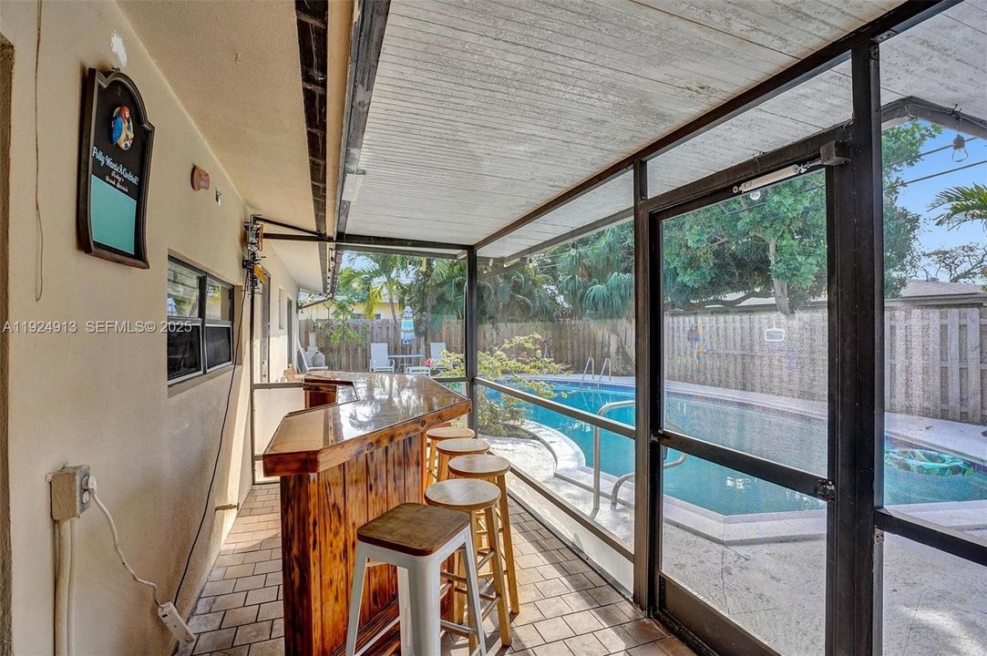 Screened in patio and bar.