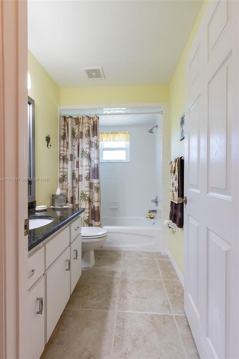 Guest bathroom is located next to the guest bedroom