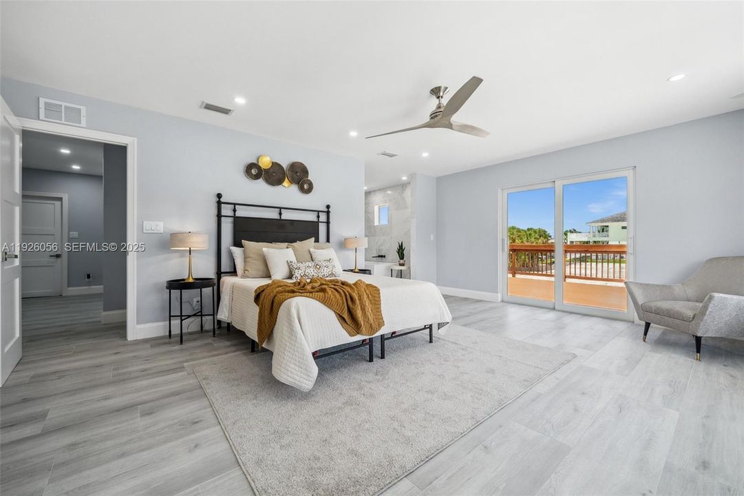 Primary Bedroom with Private Balcony and Walk-In Closet...