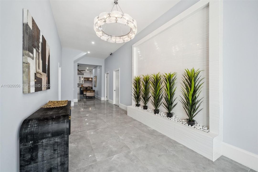 View of the foyer with shiny tile floors, high ceilings and modern touches...