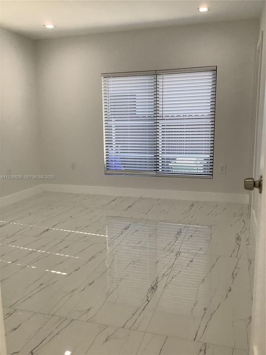 Spacious primary bedroom with walk in closet , impact windows, light and beautiful