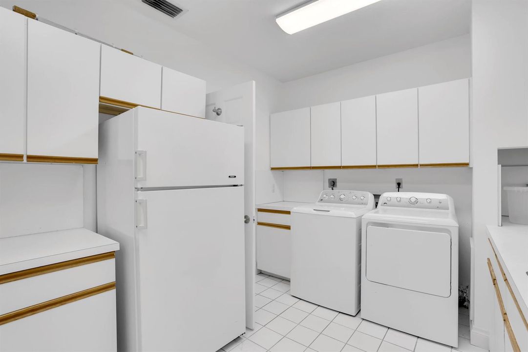 Laundry room with refrigerator