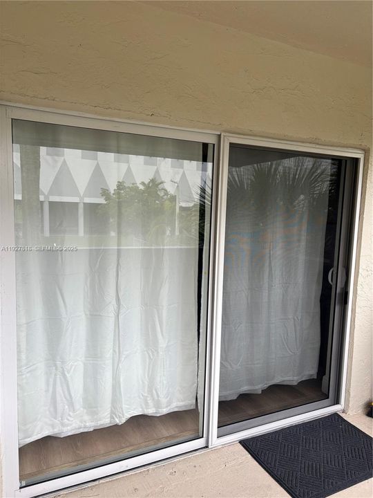Impact glass door to balcony from living room bedroom