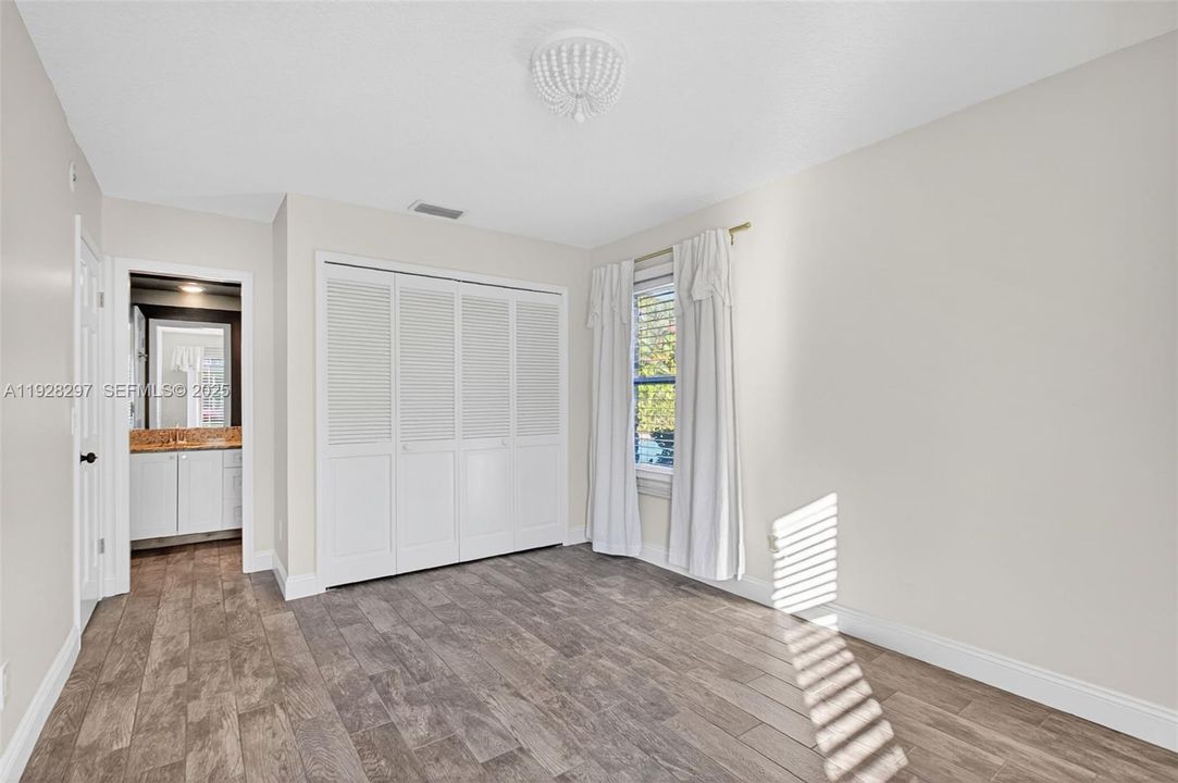 The third bedroom has a door to the shared bathroom