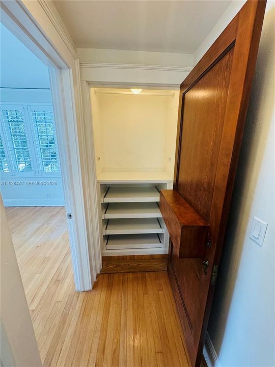 Hallway closet with original ornate door