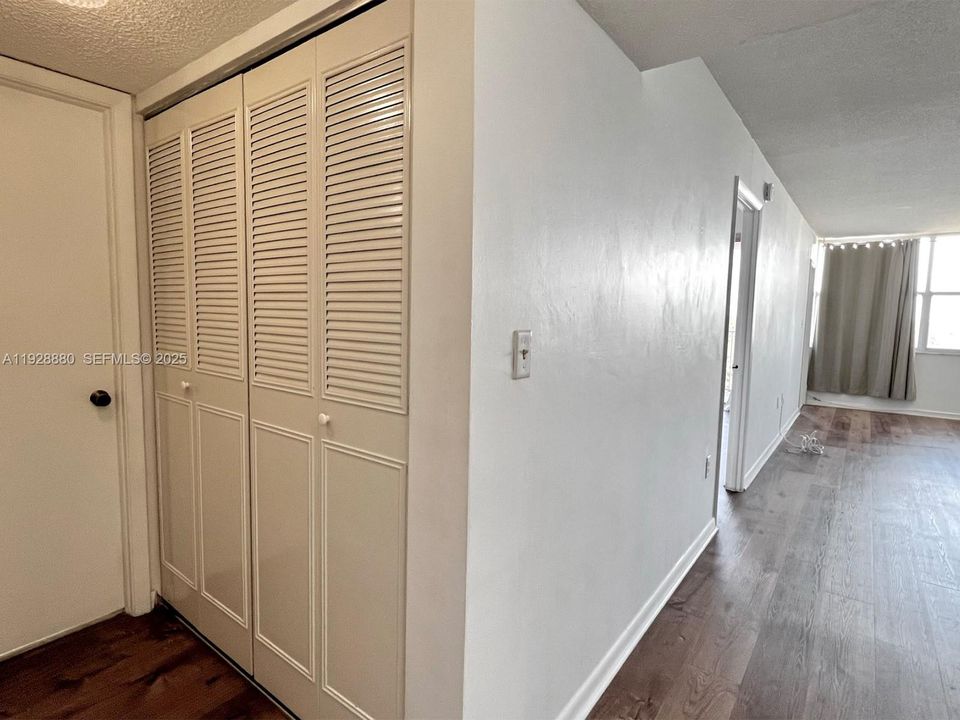 Hall from entrances to living room and bathroom